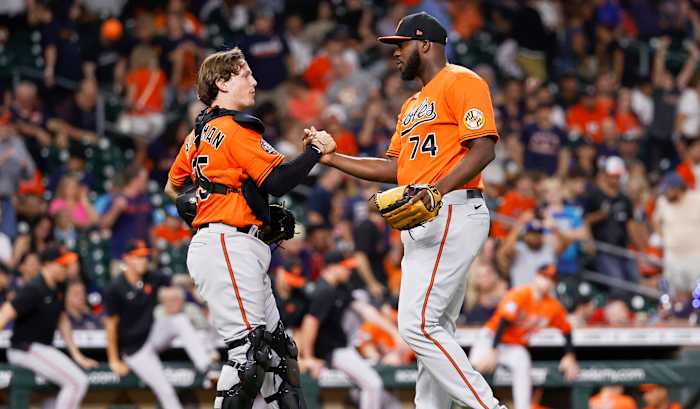 Aug 27, 2022; Houston, Texas, USA; Baltimore Orioles catcher Adley Rutschman (35) and relief pitcher Felix Bautista (74) celebrate after the Orioles defeated the Houston Astros at Minute Maid Park.
